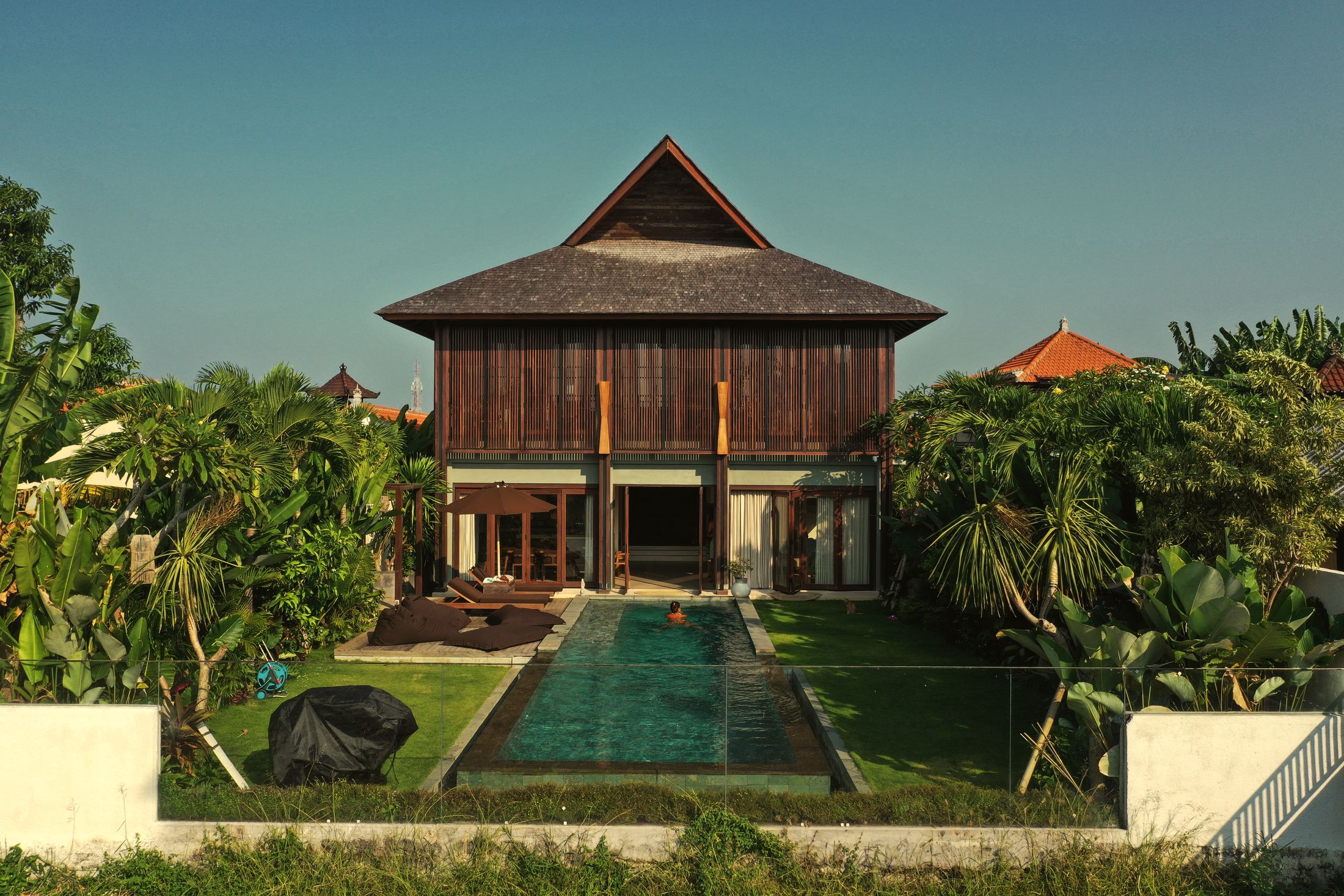 Zenjani Villa seen from above the rice fields, with its long pool and garden