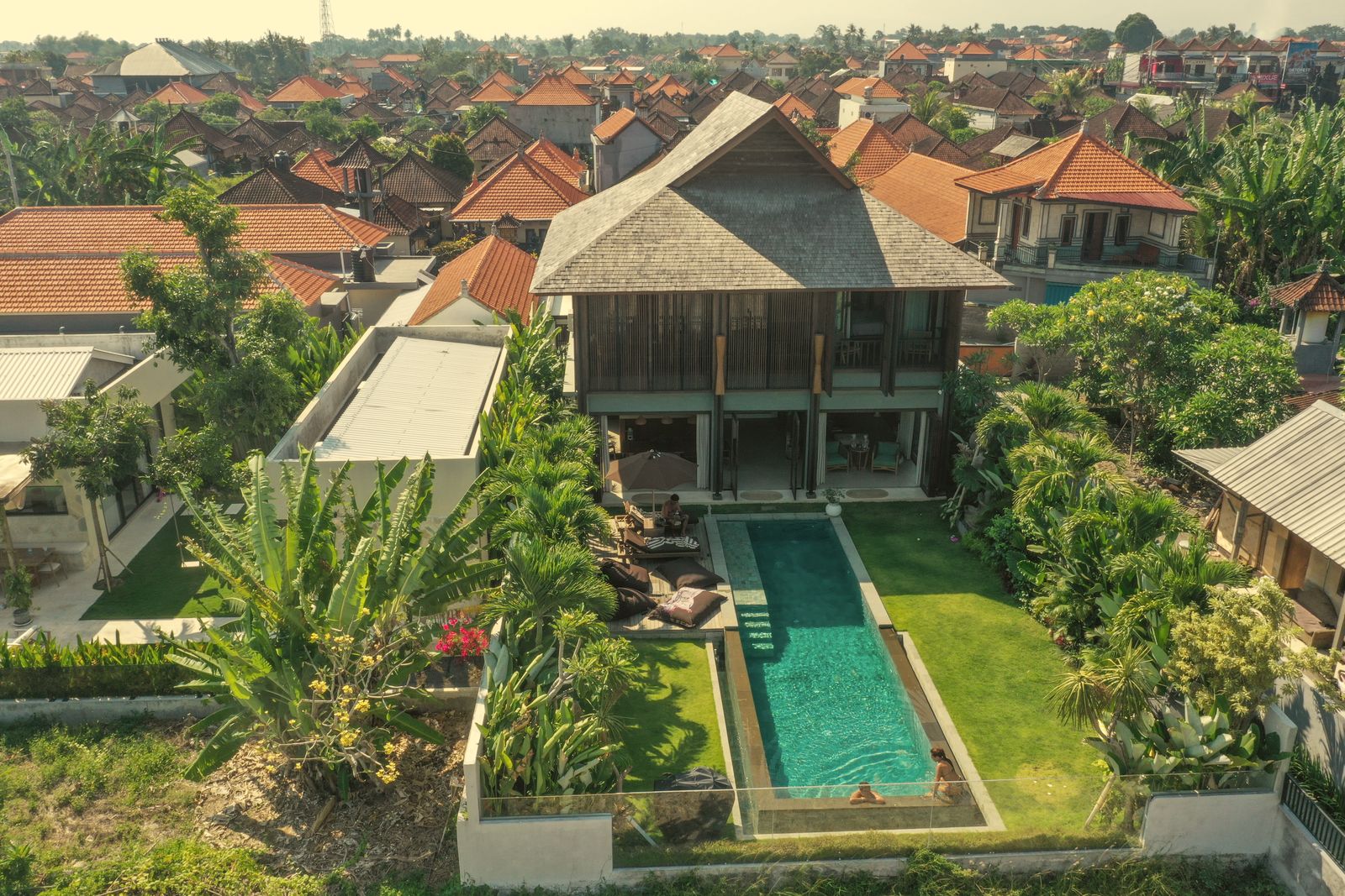 Aerial view of the villa, pool and garden among the rooftops of Beraban